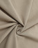 A close-up of soft, beige cotton fabric, showcasing its smooth texture and drape.