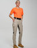 A pair of beige rip-stop poly/cotton stretch work pants displayed on a model wearing an orange shirt and sturdy boots.