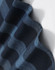 A close-up of a navy blue and black plaid flannel fabric, showcasing its soft texture and pattern.
