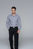A long-sleeve button-up shirt featuring a black and white check pattern, modelled by a man, with a belt and trousers.