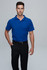 A man in a blue polo shirt and black trousers stands against a plain background. The shirt features a logo.