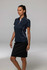 A woman wearing a navy blue polo shirt with white accents, paired with a black skirt. The shirt features a logo.