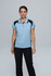 A woman stands wearing a light blue polo shirt with navy accents, paired with black pants. The shirt features a logo.