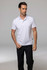 A white polo shirt modelled by a man, paired with black trousers, featuring a logo on the shirt.