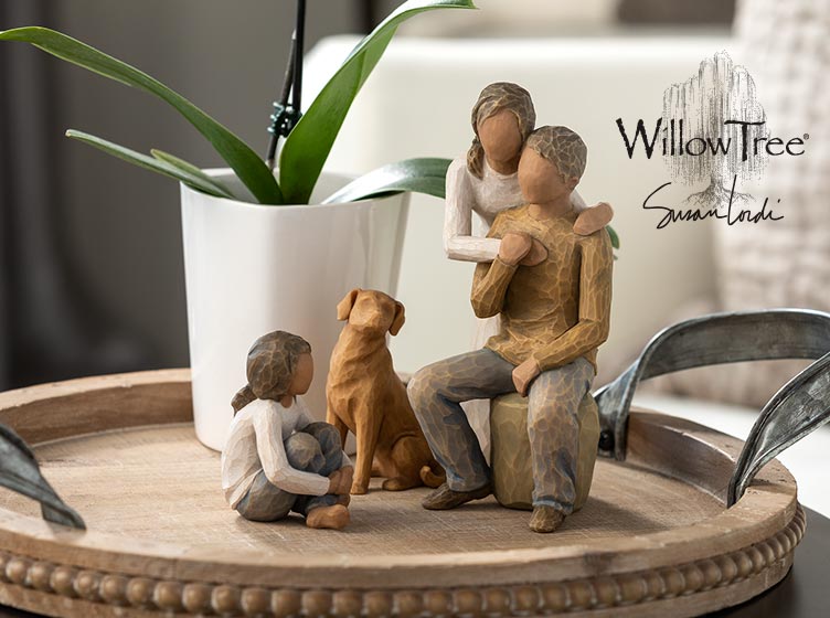 md-willow-tree.jpg Hand carved figurines of a mom, dad, and children decorating a living room table. Willow Tree by Susan Lordi.