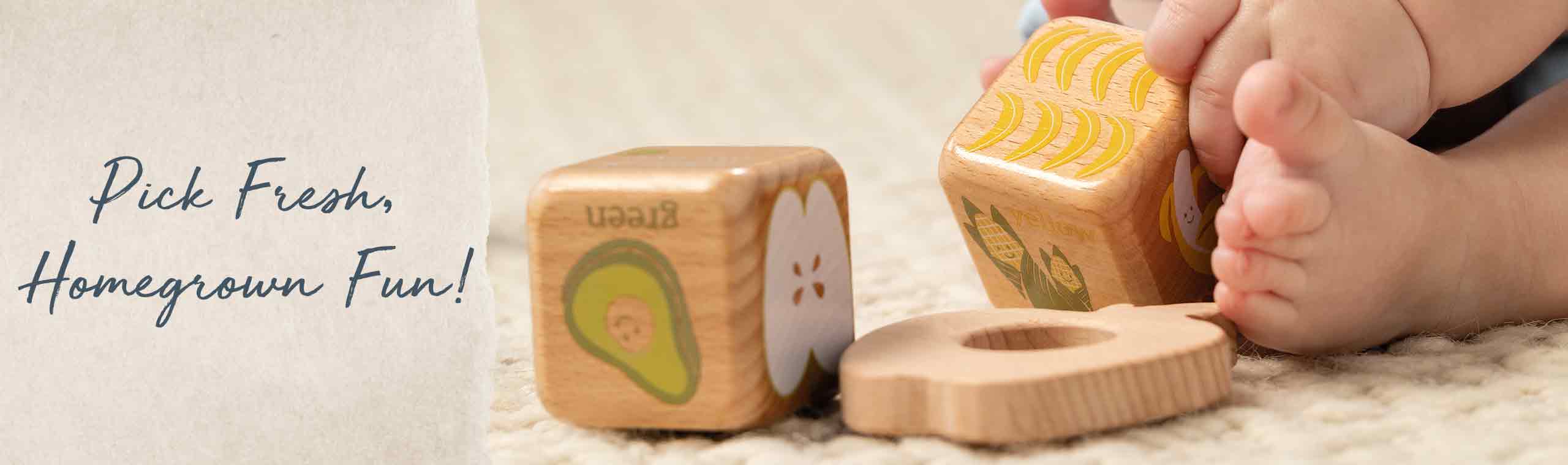 Pick Fresh, Homegrown Fun! a baby playing with wooden block with farm themed prints on them