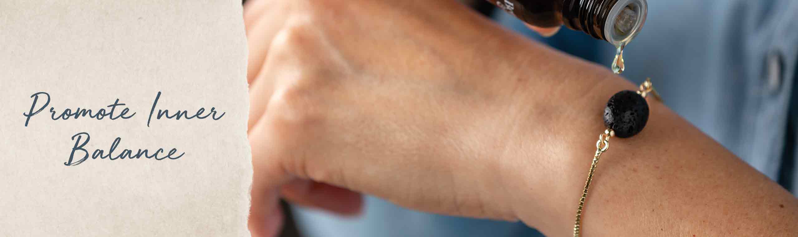 Promote Inner balance. A women pouring a drop on her lava bead bracelet