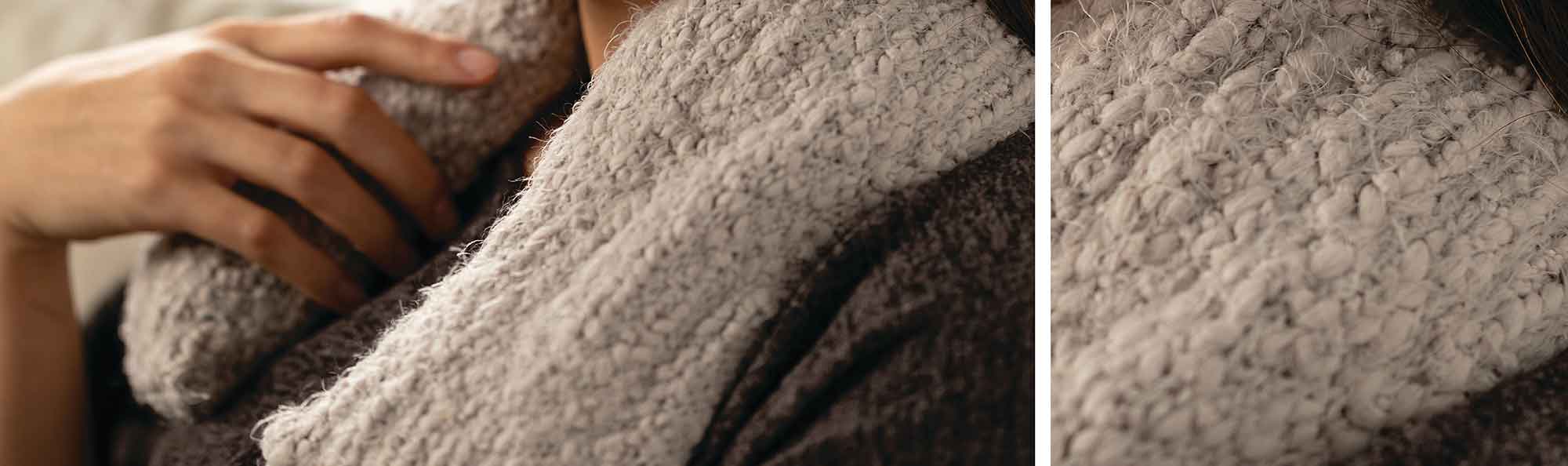 Light Gray neck wrap worn by a women. a close up of the texture of the fabric