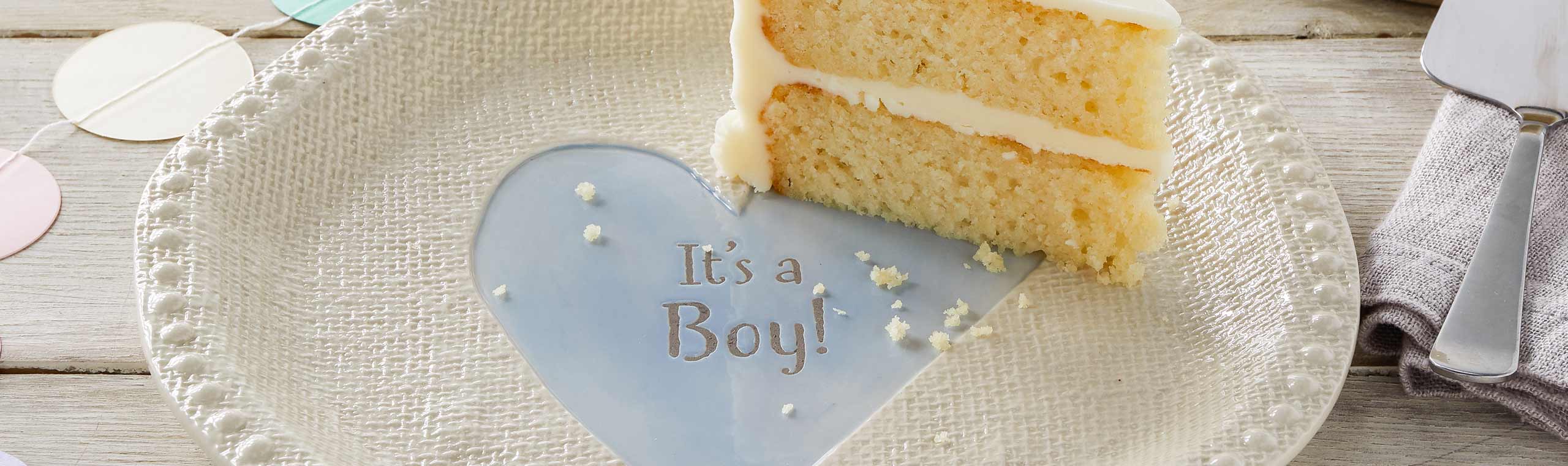 a plate with a cake and the text its a boy! in a heart