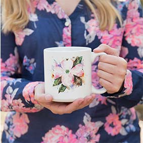 a women wearing flowers holding a cup