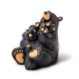 A sitting black bear figurine with three little bears sitting and climbing on his lap.