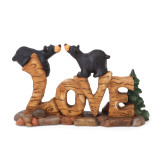 Wooden 'love' letter with black bears crawling on them