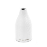 Small white textured vase with the words You are Brave at the base