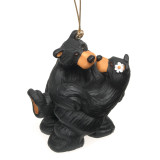 Two black bear figurines hugging one another ornament