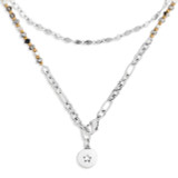 A silver wrap necklace/bracelet with various gold and silver beads, and a circular pendant with a star shape cutout.