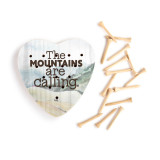 A heart shaped wood peg game that says "Where America is still Wild" on a mountain stream background, next to a set of wood pegs.