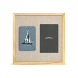 A light wood frame that has a blue tile with a sailboat on the left next to a 4x6 photo opening on a linen background.