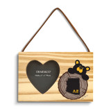 A rectangular wood hanging ornament with a 2x2 inch heart shaped photo opening next to an image of a black bear peeking over a wood stump with Arizona on it.