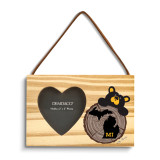 A rectangular wood hanging ornament with a 2x2 inch heart shaped photo opening next to an image of a black bear peeking over a wood stump with Michigan on it.