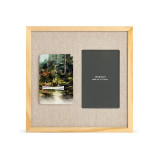 A light wood frame with a tile on the left that has a watercolor image of a canoe on a stream, next to a 4x6 photo opening with a linen mat.