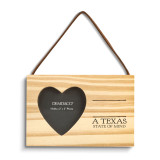 A rectangular hanging wood ornament with a heart shaped two inch photo opening next to the saying "A Texas State of Mind" under two black lines with room for personalization.