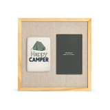 A light wood frame with a tile that has a green tent and says "Happy Camper" next to a 4x6 photo opening on a linen background.