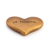Heart shaped rustic gold metal token that says "So Thankful".