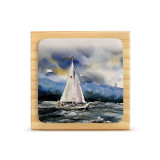 A square wood plaque with a tile attached that has a watercolor image of a sailboat on the sea.