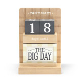 A wood countdown calendar that says "Can't Wait" and "days until". The top shelf has dark gray number blocks and the bottom shelf has different blocks that say what the countdown is for.