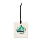 A square hanging tile ornament with a graphic image of a green sailboat on a light green background.
