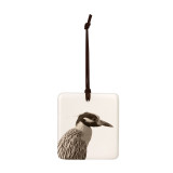 A white square tile hanging ornament with the image of a heron.