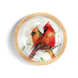 A light wood round paperweight with a glass dome over a watercolor image of a pair of cardinals on a branch.