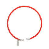 A round bracelet made of small red beads.