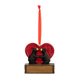 A hanging ornament of two black bears looking at each other in front of a large red heart on a rectangular base that can be personalized.
