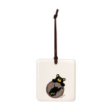 A square cream hanging tile magnet ornament with an illustration of a black bear peeking over a wood stump with the state of West Virginia on it.