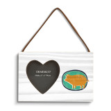 A rectangular wood hanging frame with a heart shaped 2 inch photo opening next to an illustration of a gold pig on a green background.