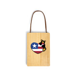 A wood hanging gift card ornament with an illustration of a black bear holding a heart with the American flag. The back has a holder for a gift card.