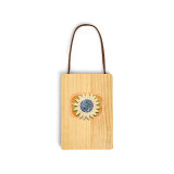 A wood hanging gift card ornament with an illustration of a yellow sunflower on an orange background on the front. The back has a holder for a gift card.