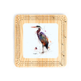 A light wood cribbage board with a watercolor image of a heron in the middle.