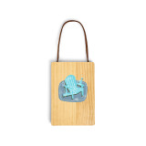 A wood hanging gift card ornament with an illustration of a light blue Adirondack chair on a blue background on the front. The back has a holder for a gift card.