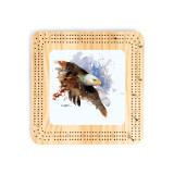 A light wood cribbage board with a watercolor image of a bald eagle in flight.