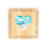 A light wood cribbage board game with heart shaped graphic artwork of a bicycle and white fence at a beach in the middle.