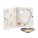 A heart shaped nativity themed puzzle where the pieces are inside 12 countdown holes in a white box.
