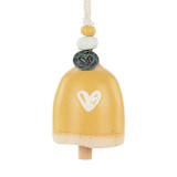A mini yellow bell with a cream heart. There are beads and a metal token at the top of the bell.