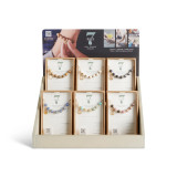 A two tier light wood displayer with an assortment of 7 days necklaces in packaging boxes.