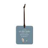 A square blue hanging tile magnet ornament that says "A Day at the lake Keeps the Bother Away" with an image of Pooh and Piglet.