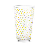 A clear pint glass with a colorful confetti pattern.