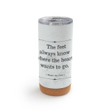 A white cork bottom tumbler with a clear plastic lid. The tumbler says "The feet always know where the heart wants to go" with the hundred acre wood lightly in the background.