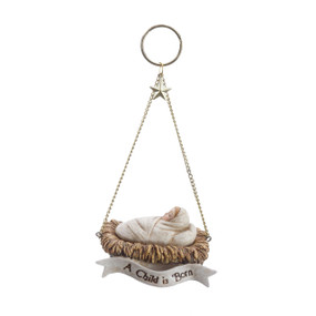 Hanging baby cradle with baby figurine ornament - 'a child is born' white banner attatched to cradle