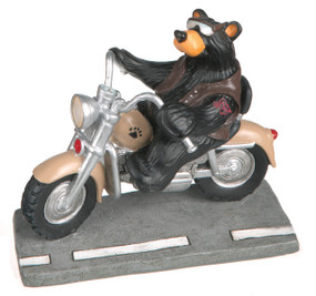 Black bear figurine riding on motorcycle under street plaque